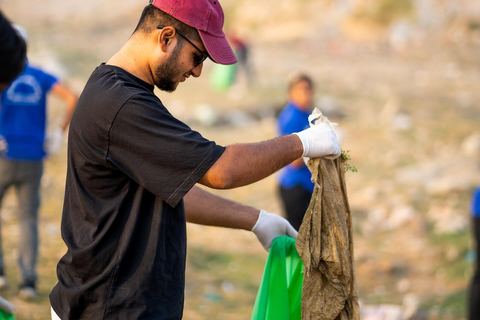 A volunteer bagging litter